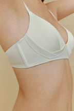 Side of woman in white silk bra 