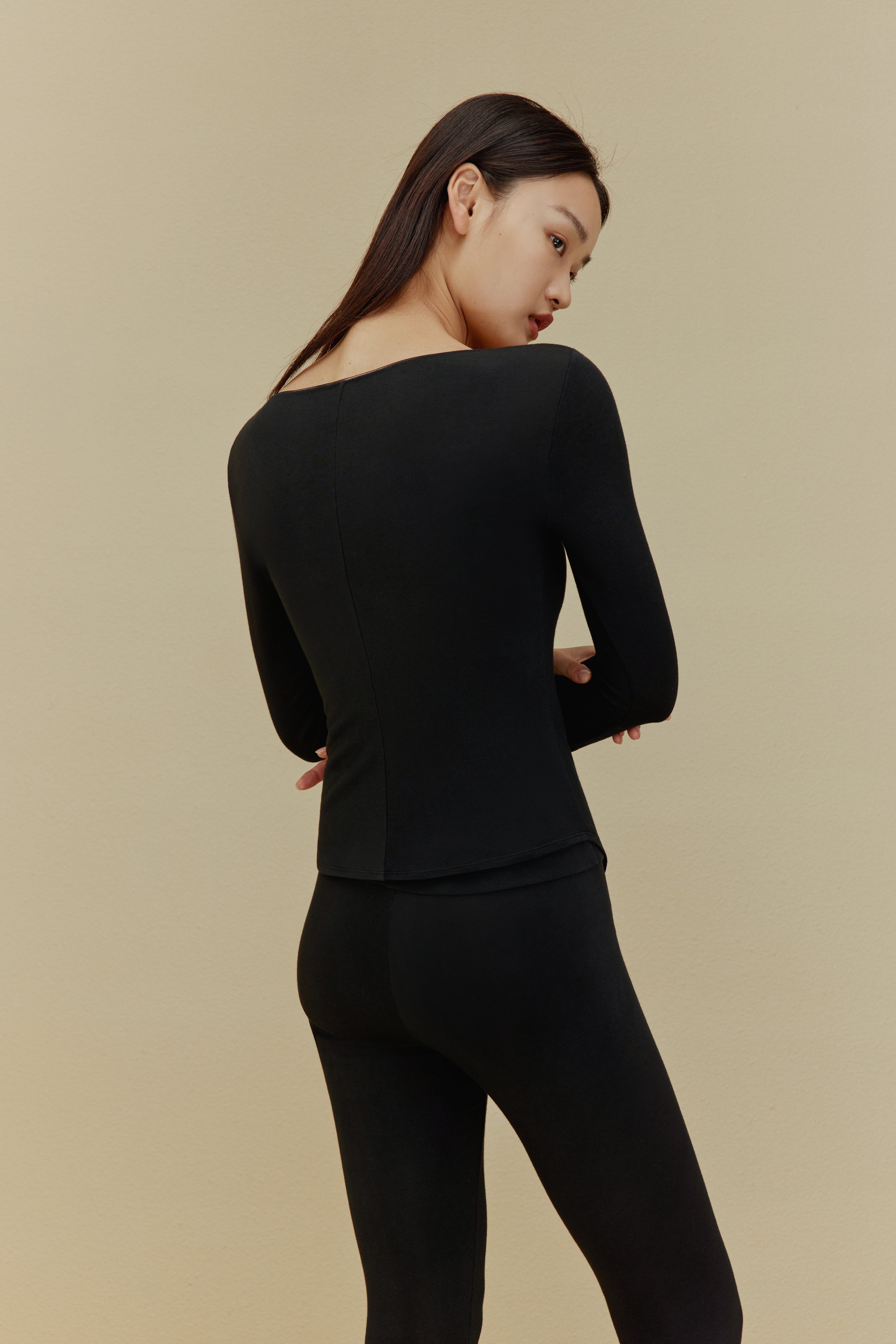 back of women in black thermal underwear set