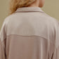 Back view of woman wearing tan pajama shirt
