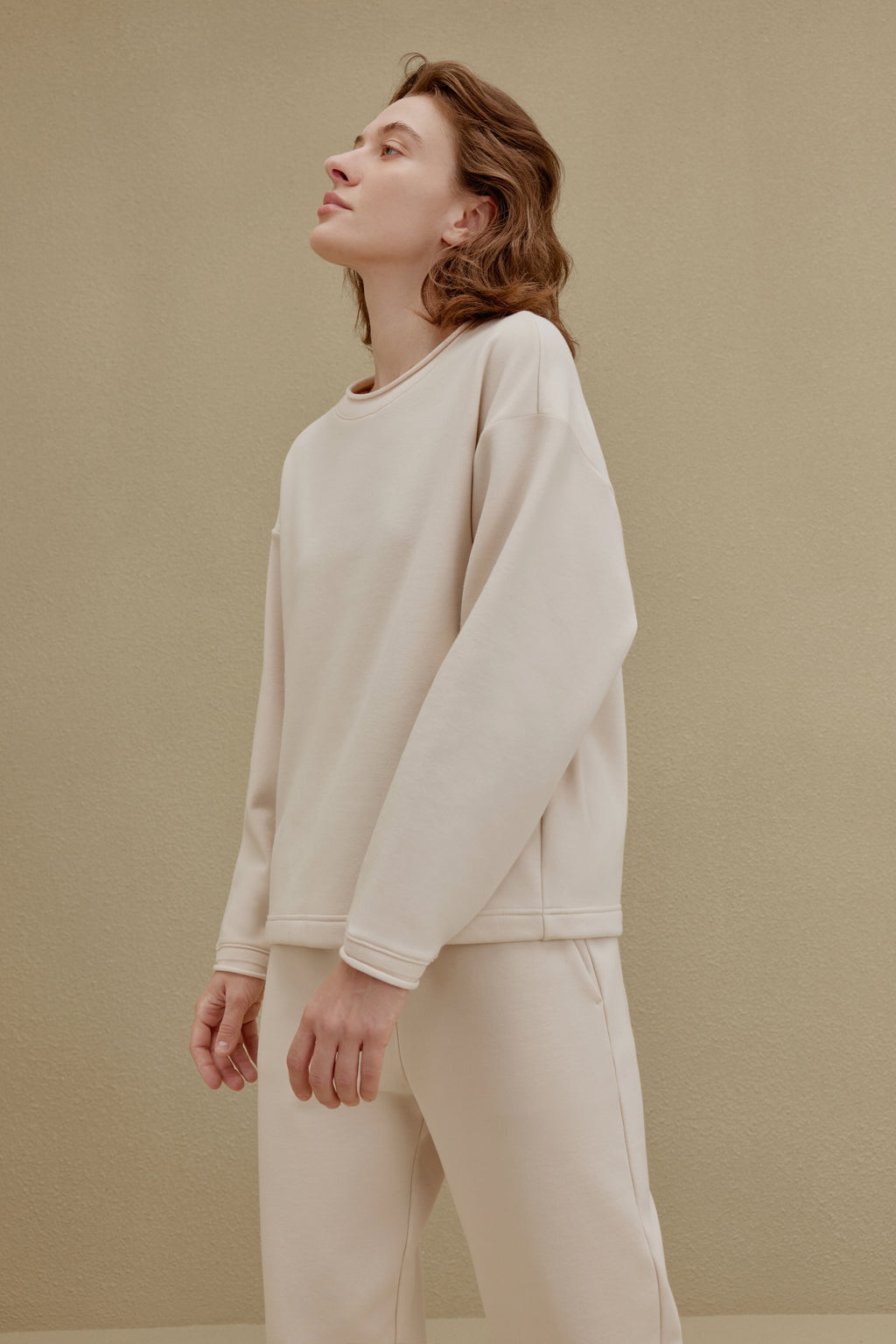 woman in off-white top and pants