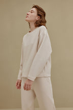 woman in off-white top and pants