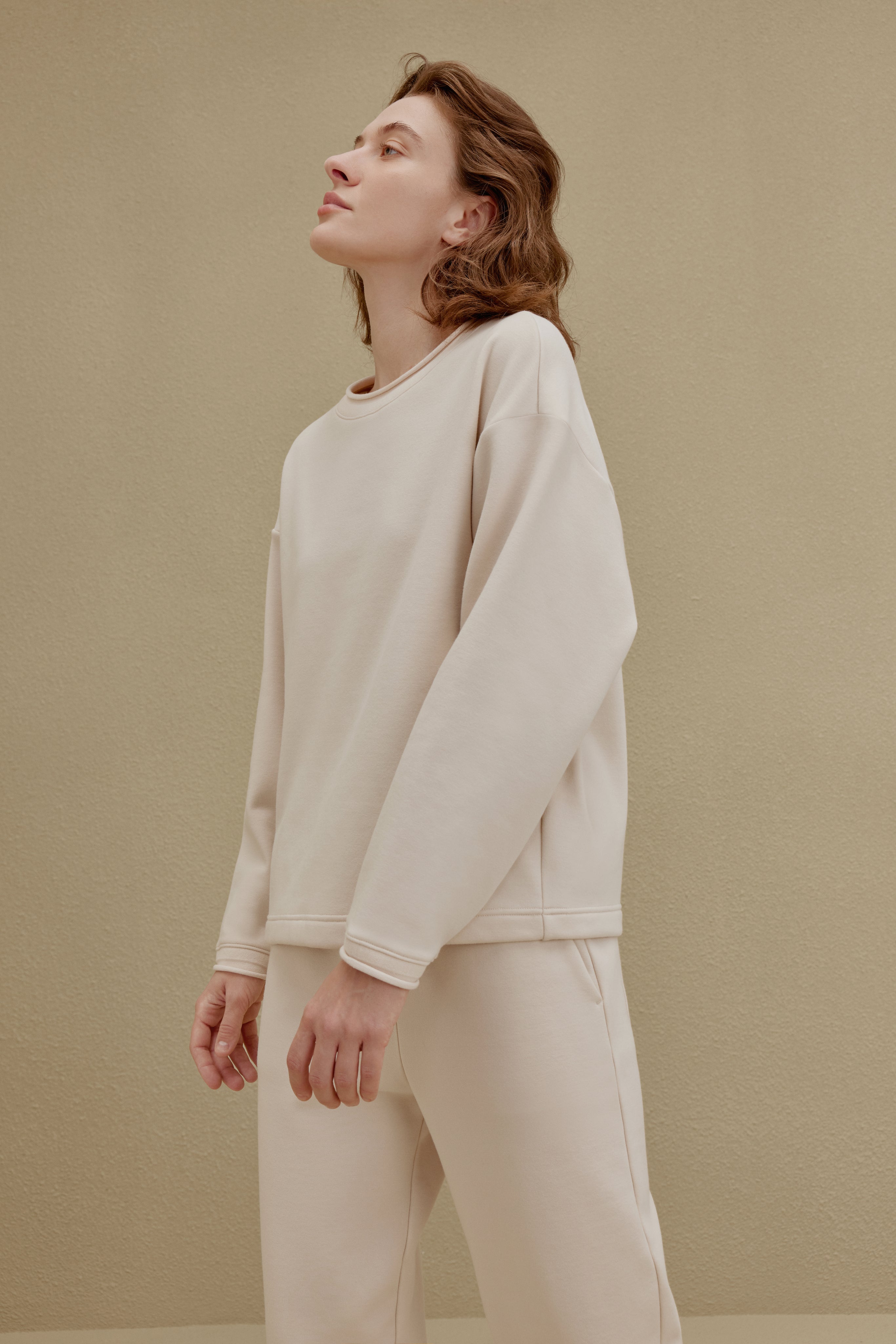woman in off-white top and pants