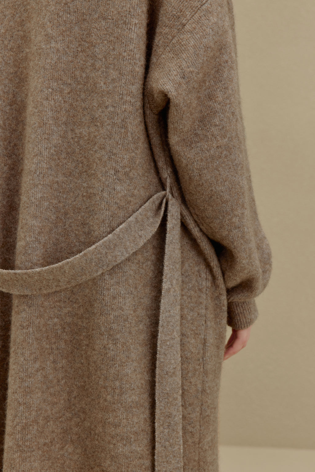 close up of the brown knitted coat