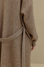 close up of the brown knitted coat