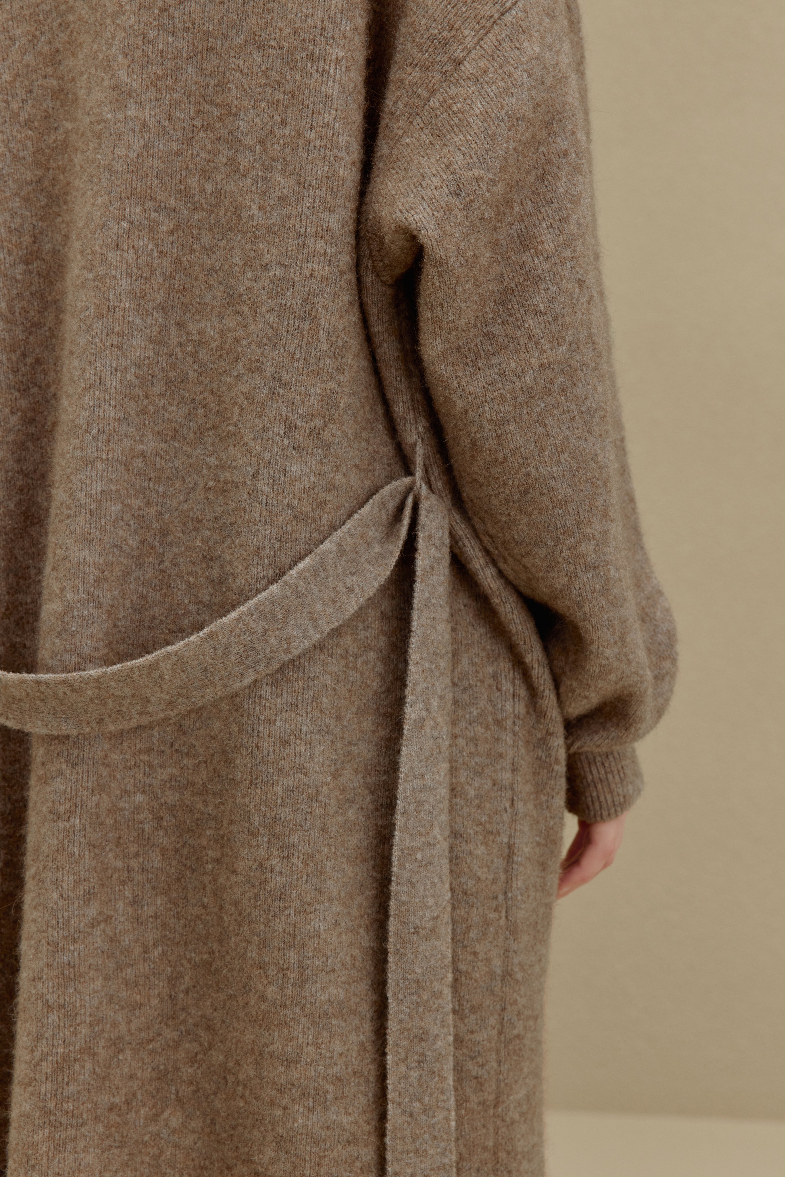 close up of the brown knitted coat