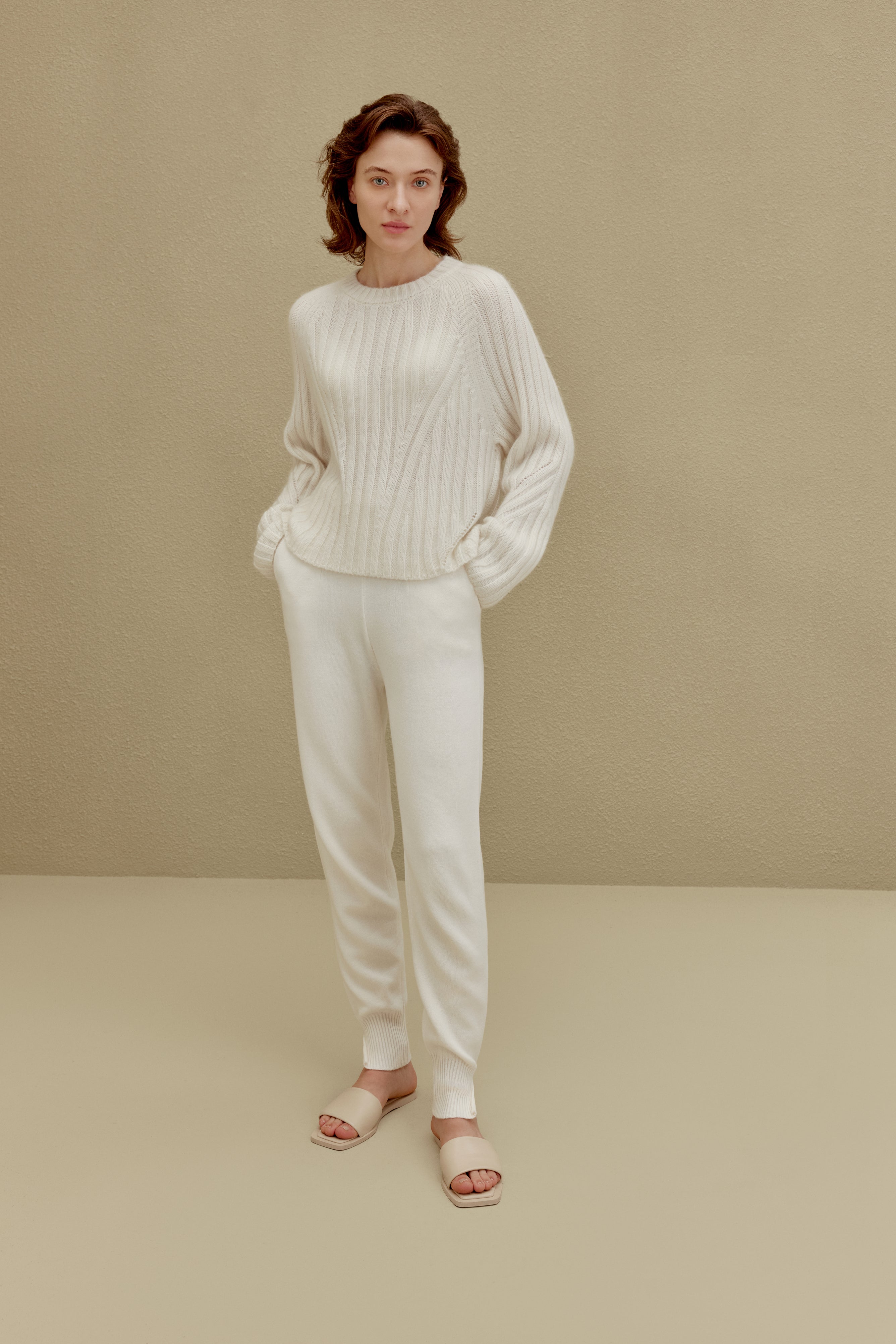 women in white ribbed sweater and joggers