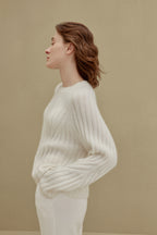 side of women in white ribbed sweater