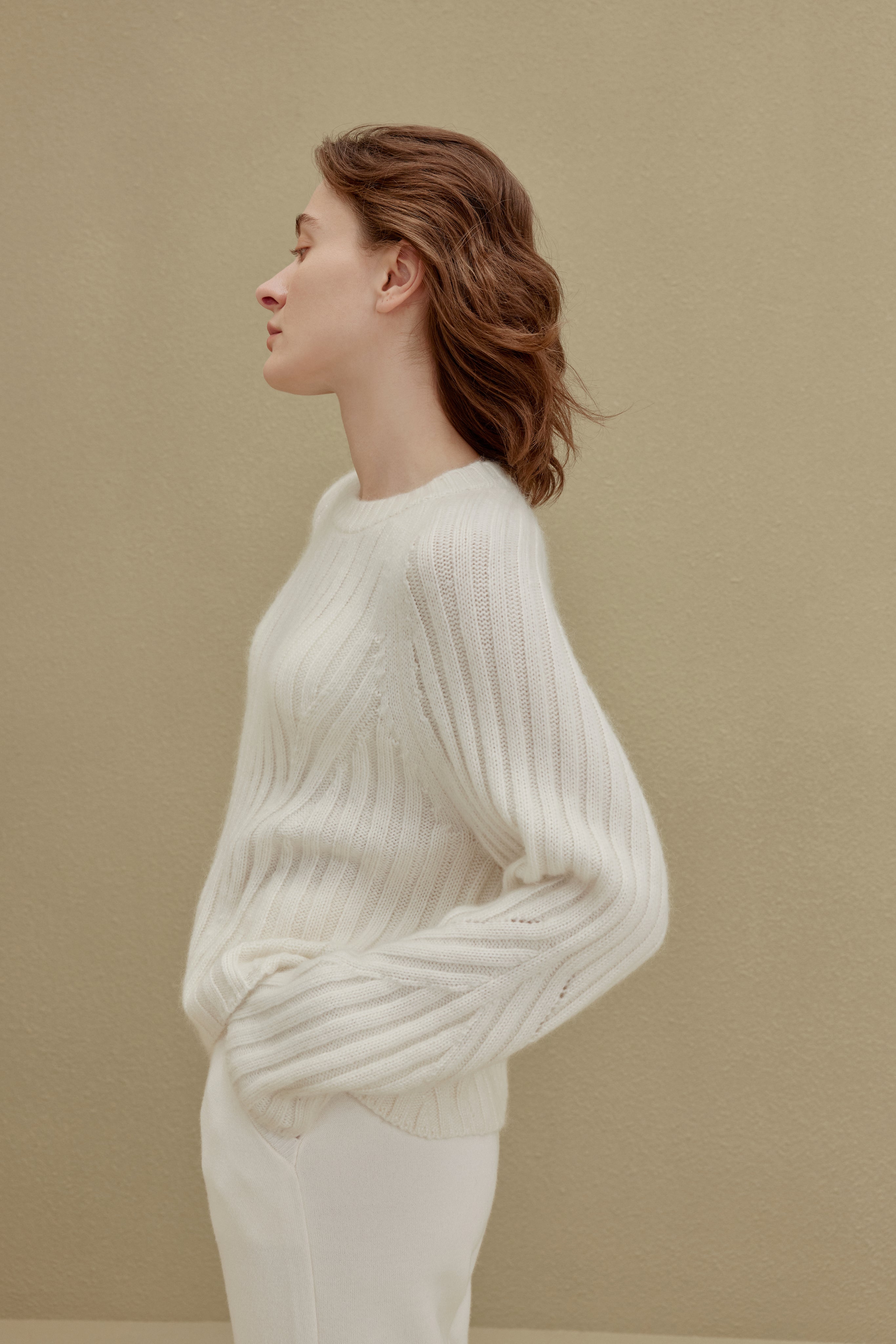 side of women in white ribbed sweater