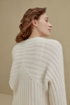 back of women in white ribbed sweater