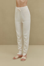 women in white knitted joggers