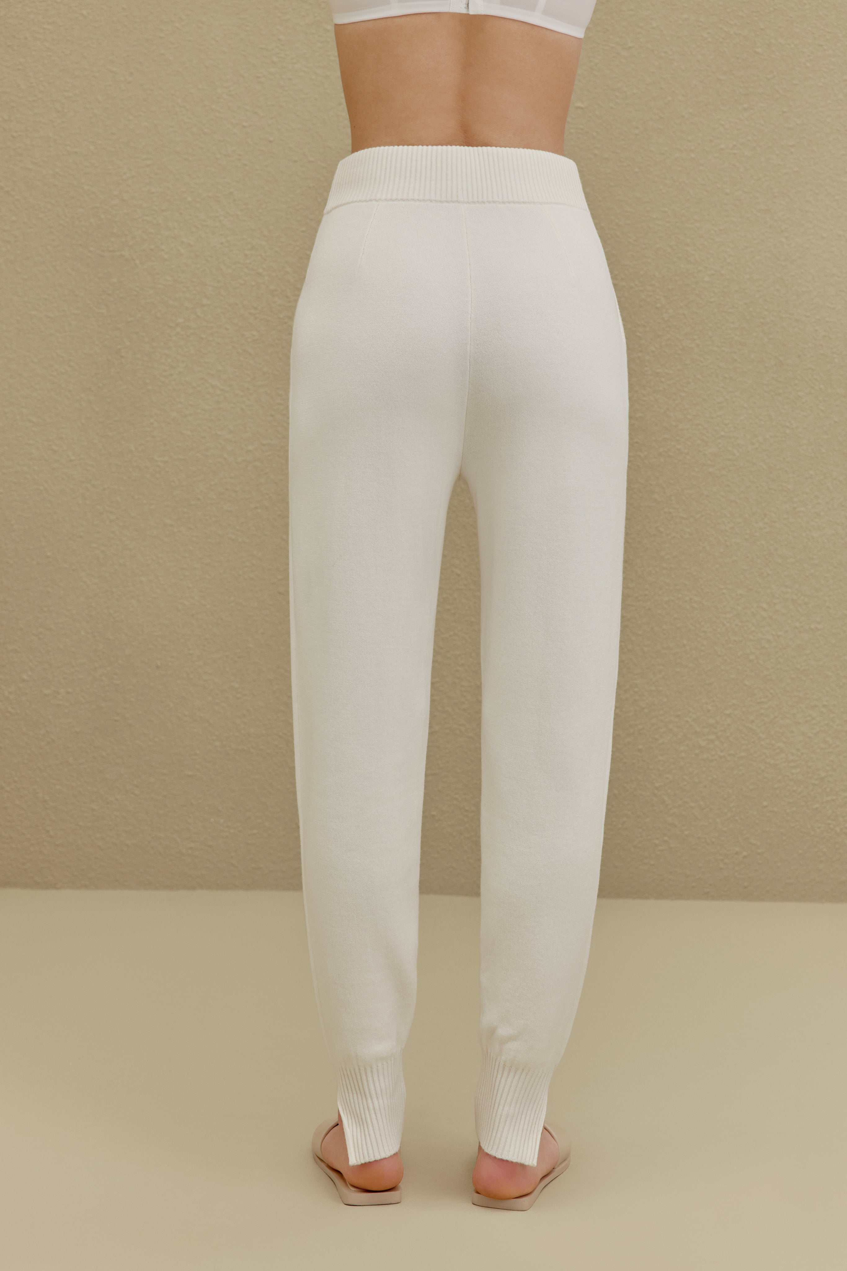 back of women in white knitted joggers