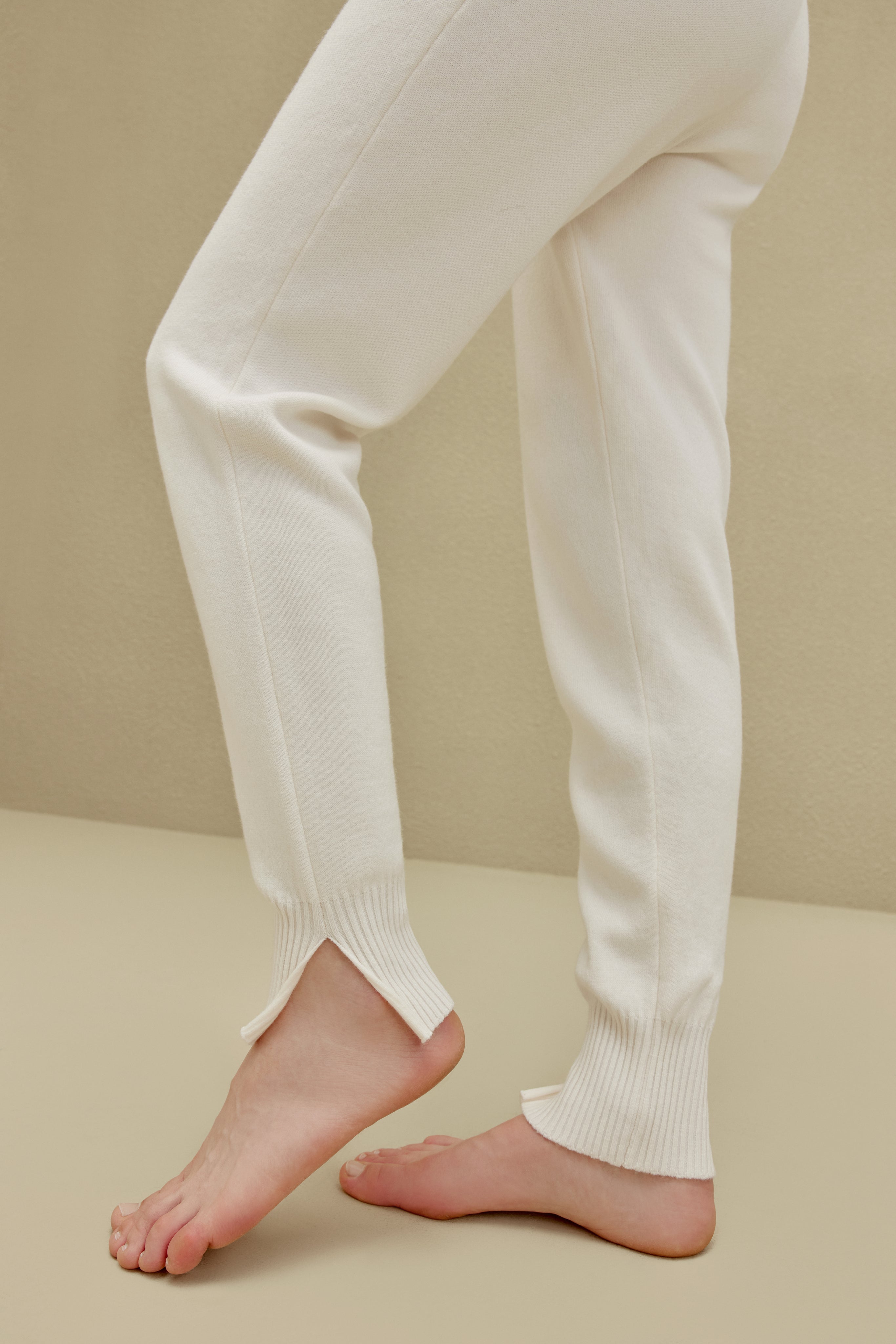 close up view of women in white knitted joggers