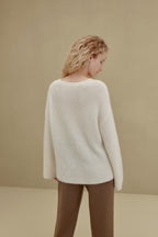 back of women in white sweater and brown knitted joggers