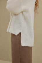 close up view of women in white knitted sweater