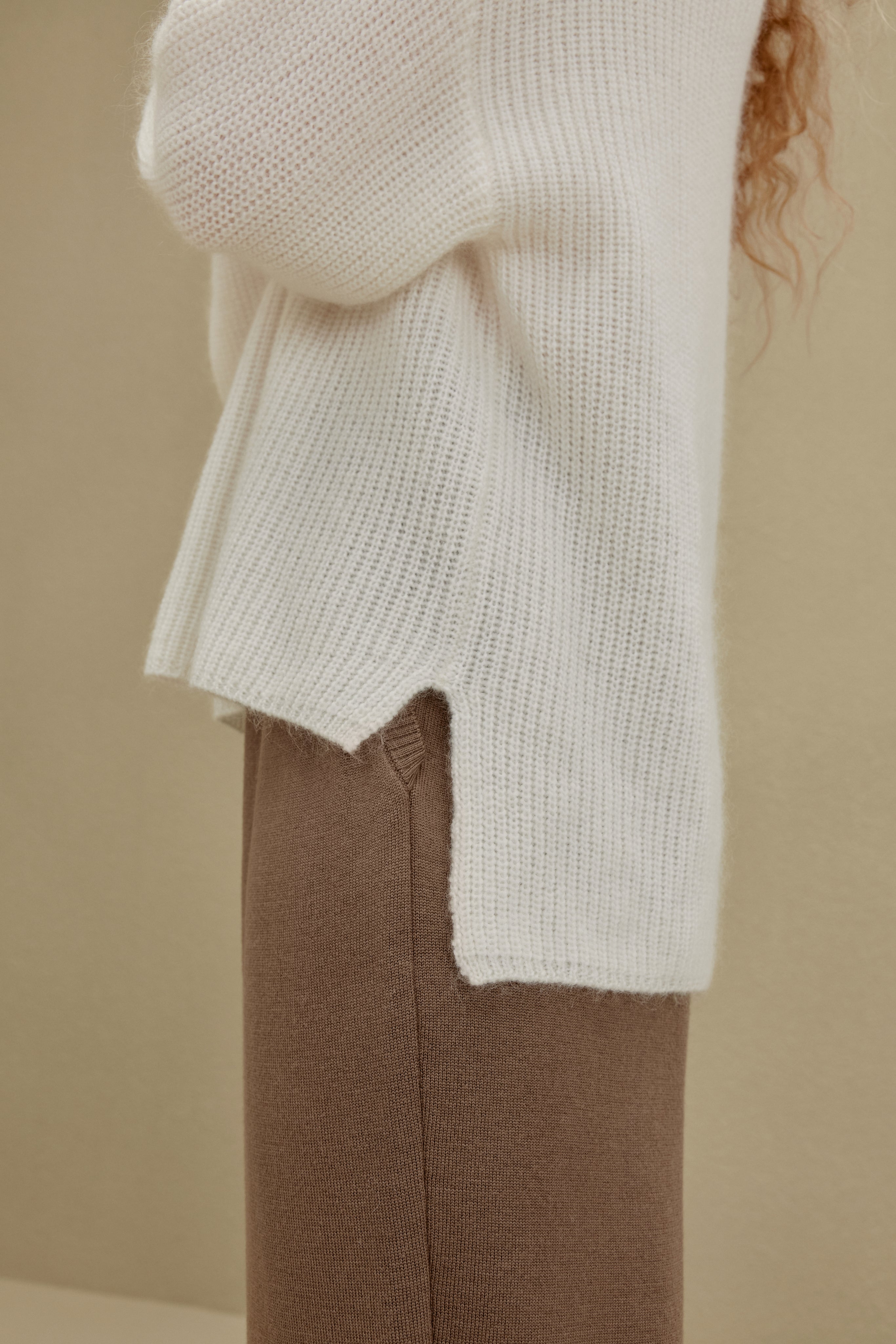 close up view of women in white knitted sweater