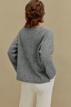 back of women in gray sweater