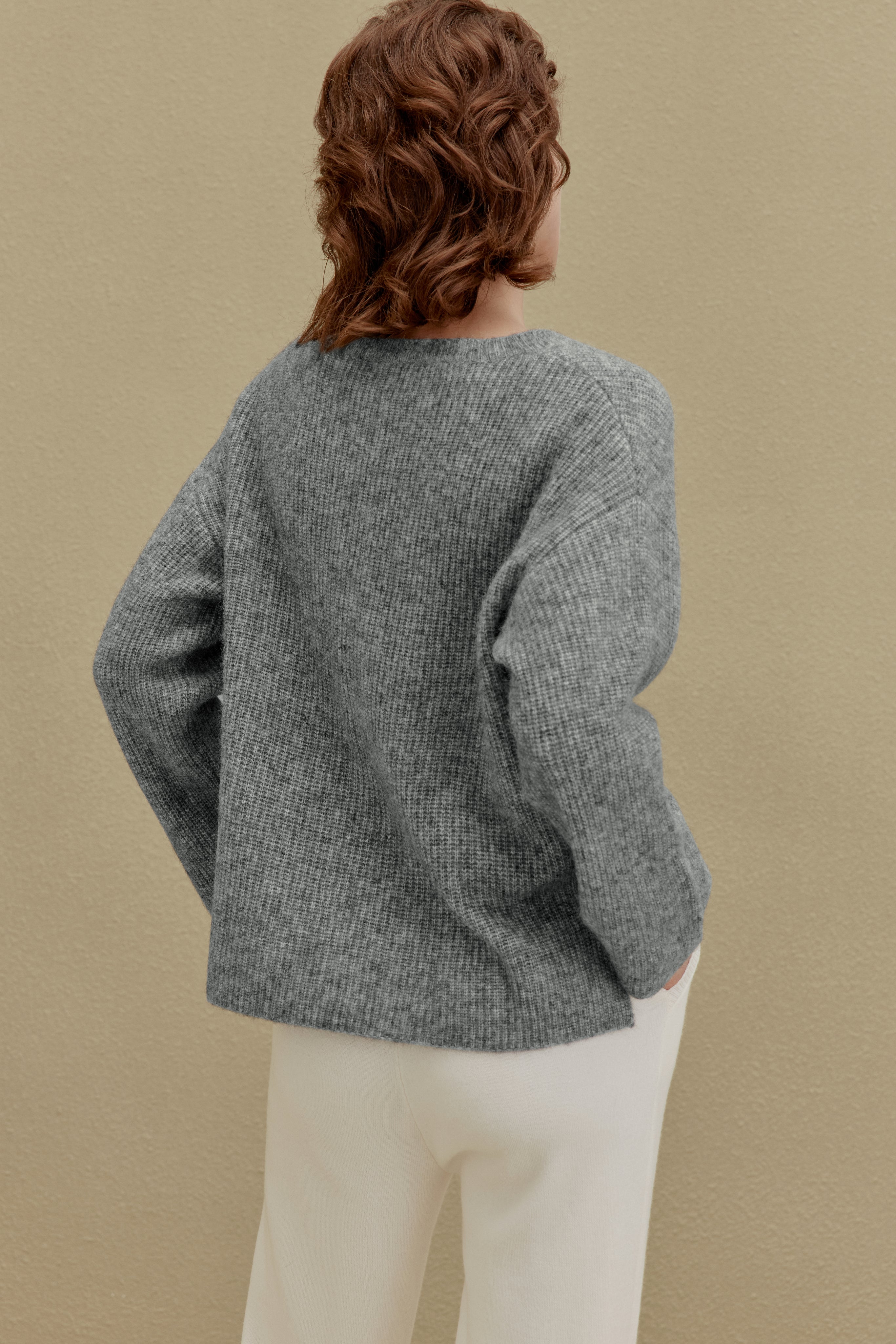 back of women in gray sweater