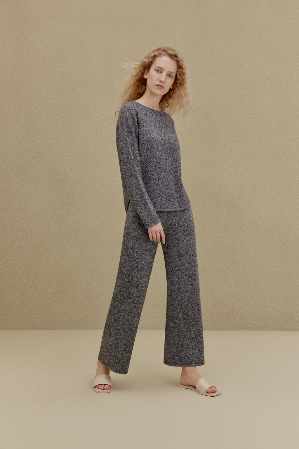 Woman in black top and wide-leg pants