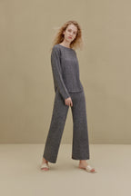 Woman in black top and wide-leg pants
