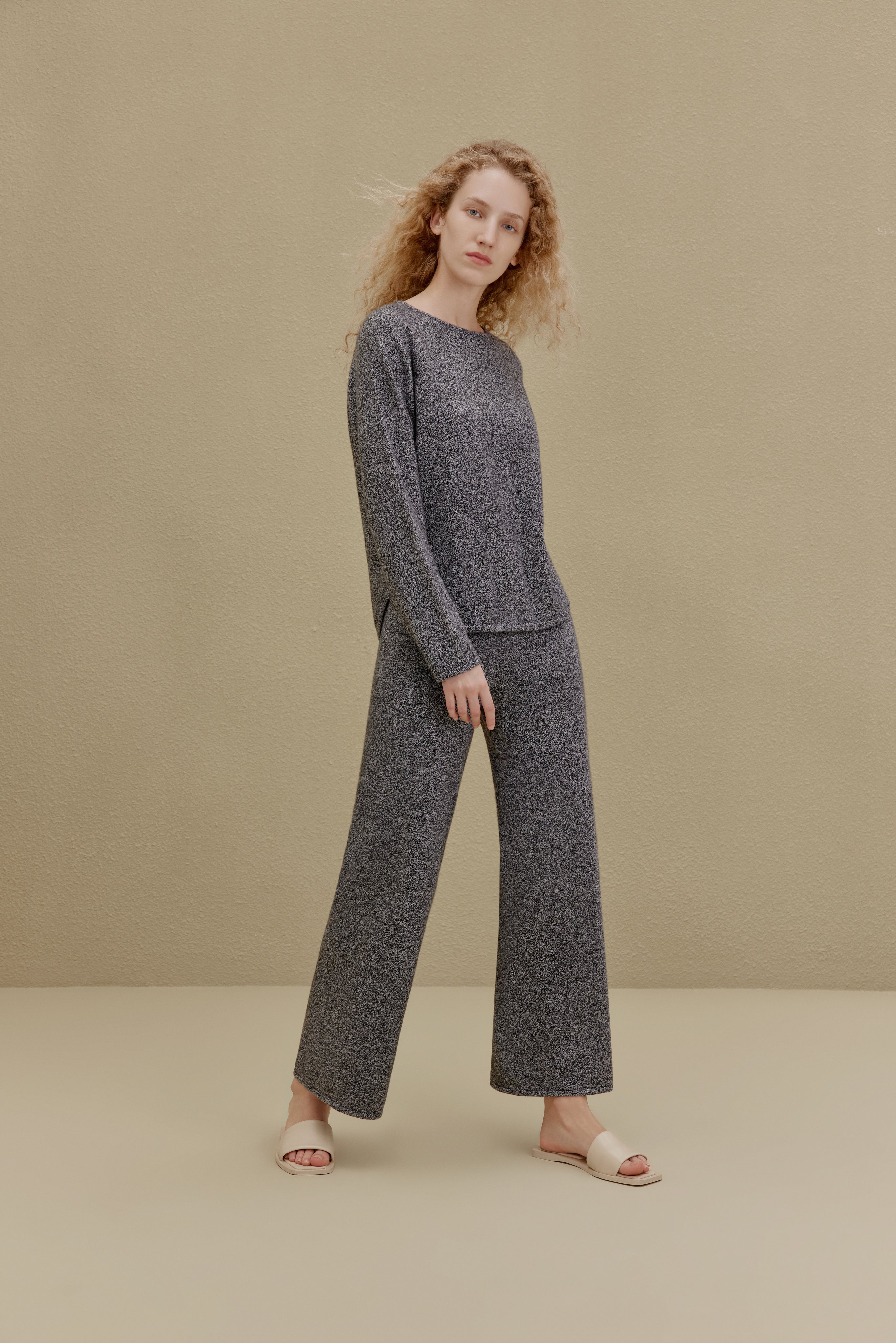 Woman in black top and wide-leg pants