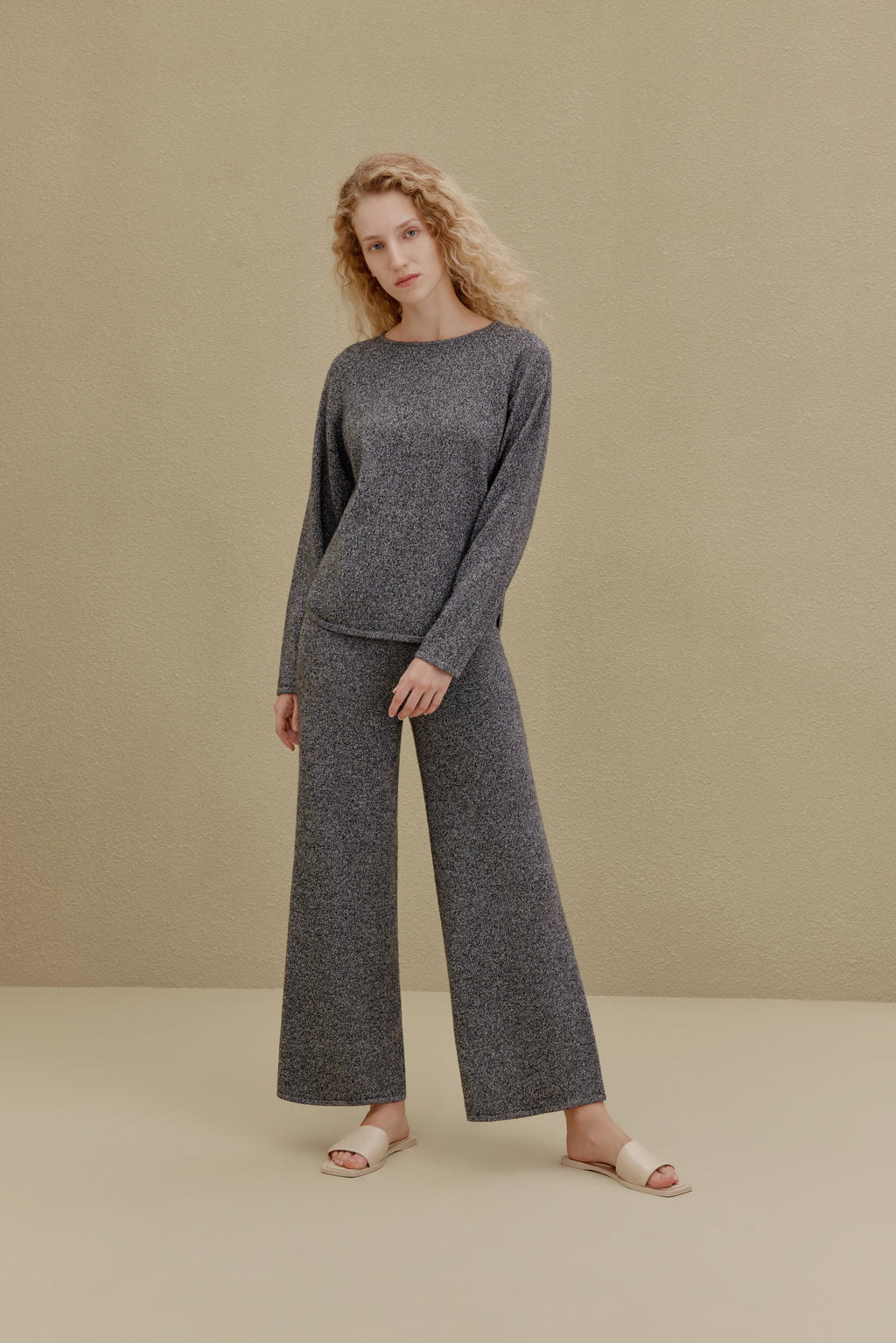 Woman in black top and wide-leg pants
