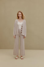 Woman in off white top and wide-leg pants