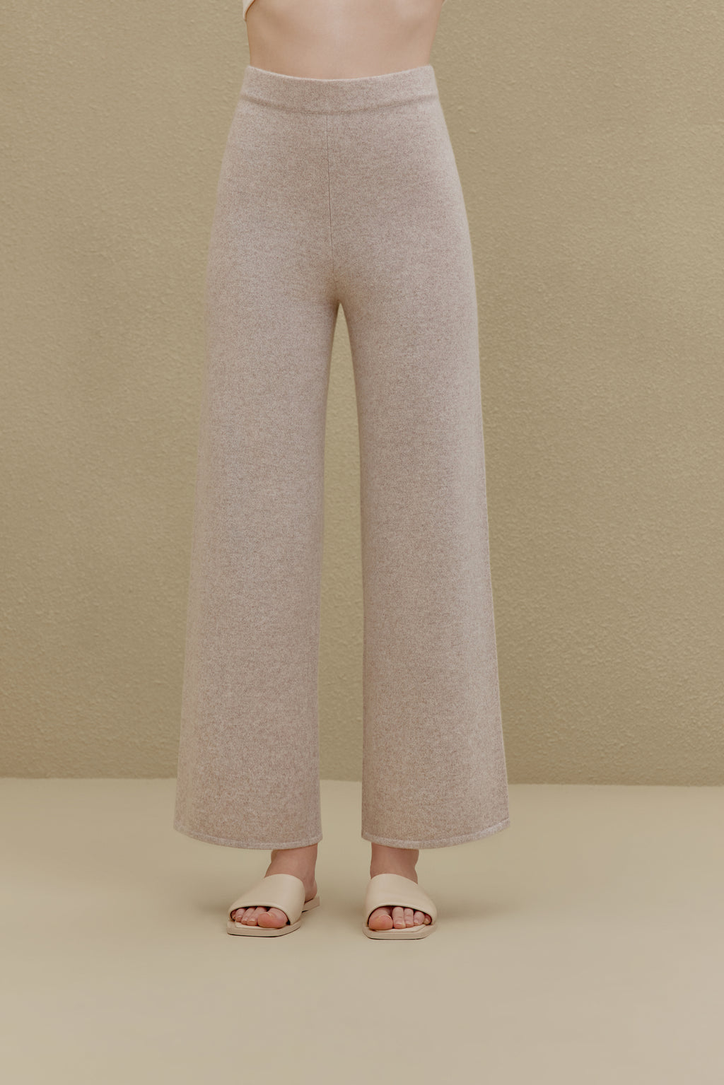 Woman in off white wide-leg pants