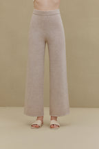 Woman in off white wide-leg pants