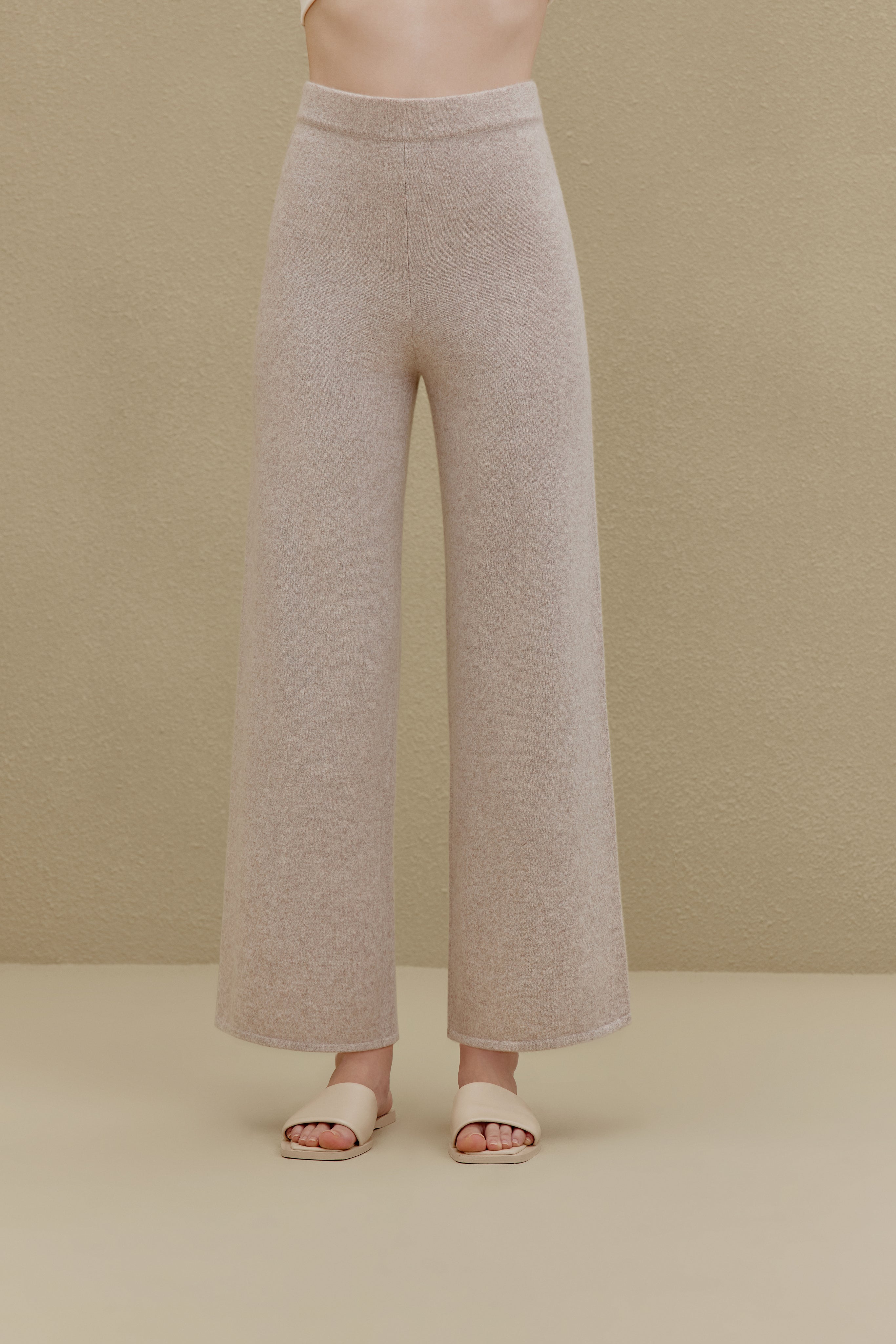 Woman in off white wide-leg pants