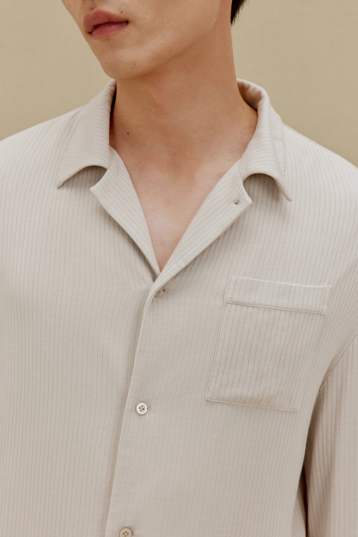 Man in off-white pajama top