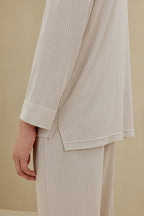 Side view of man in off-white pajamas