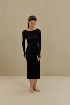 woman in black long sleeve top and midi skirt