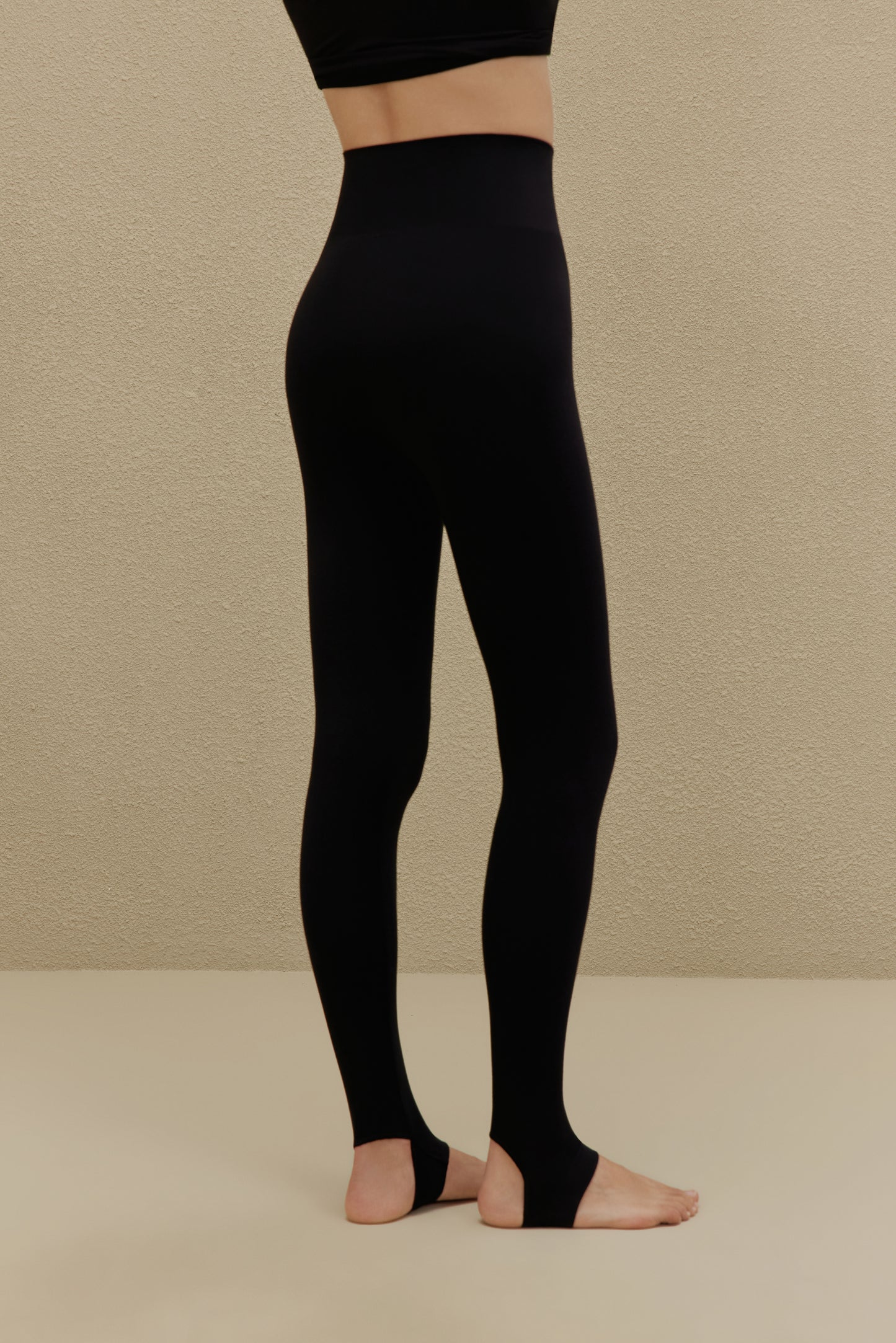 woman wearing a black stirrup leggings