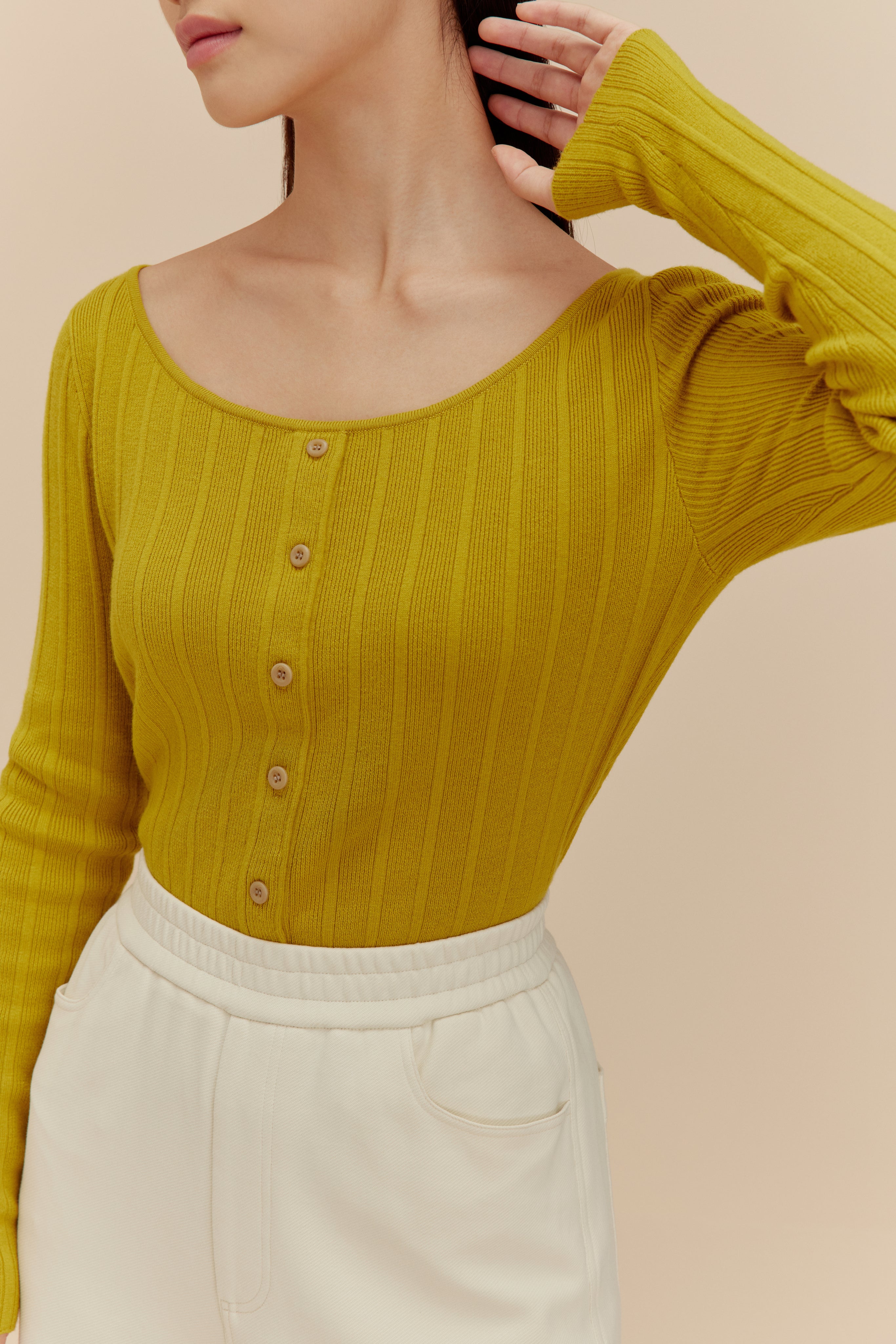 woman in golden yellow cardigan