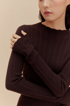 close up of woman in brown sweater 