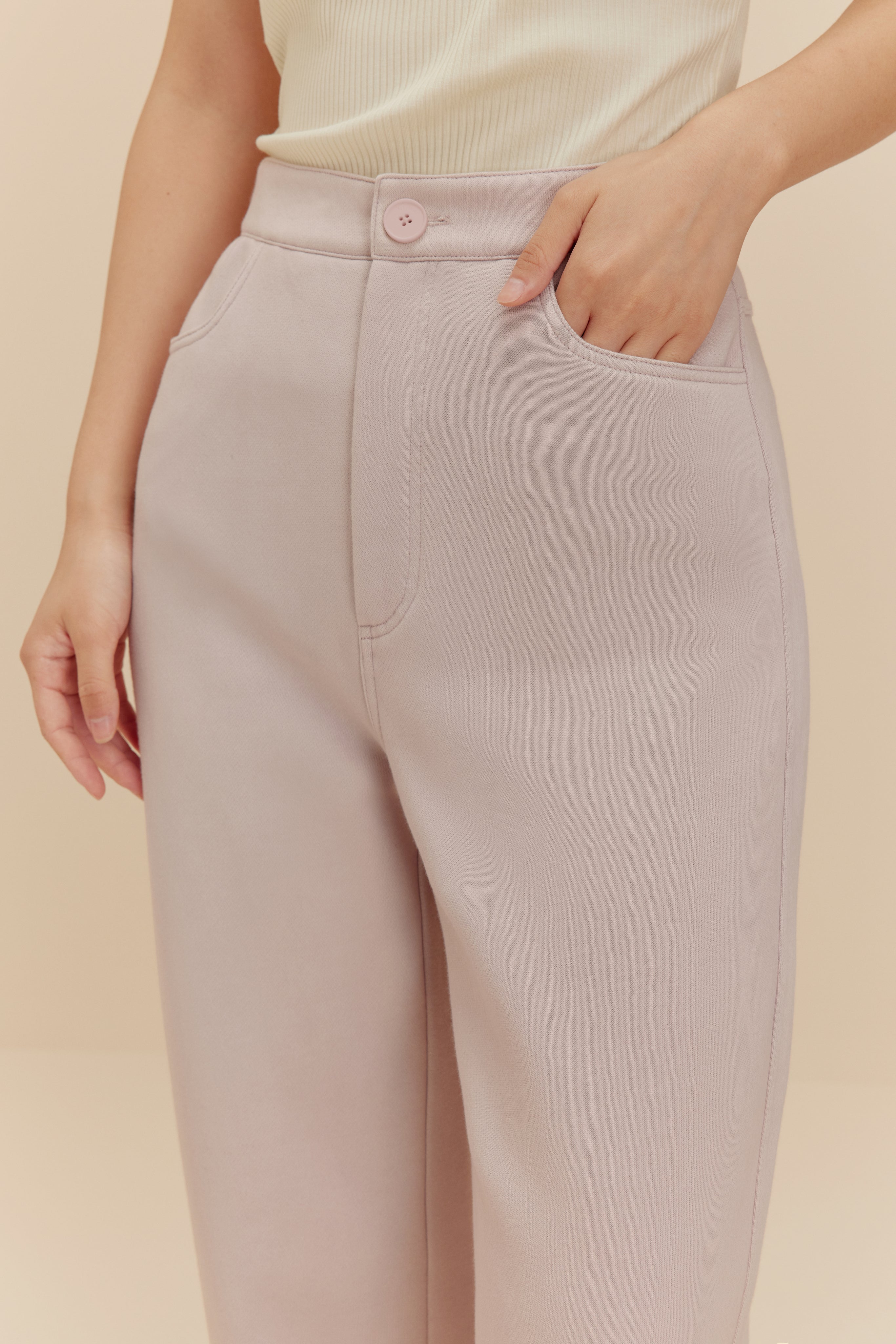 Close up of woman in light purple pants