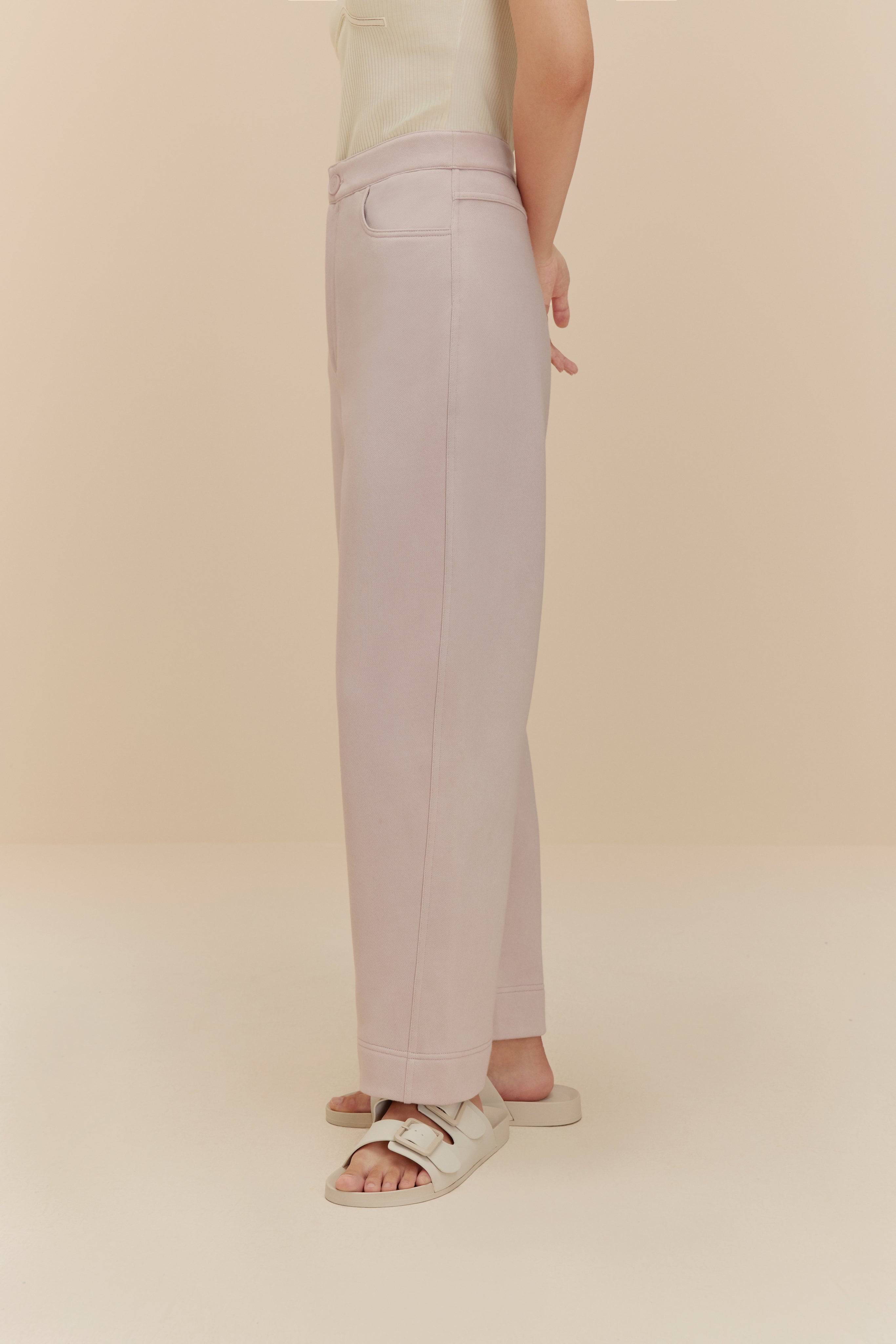 side of woman in light purple pants