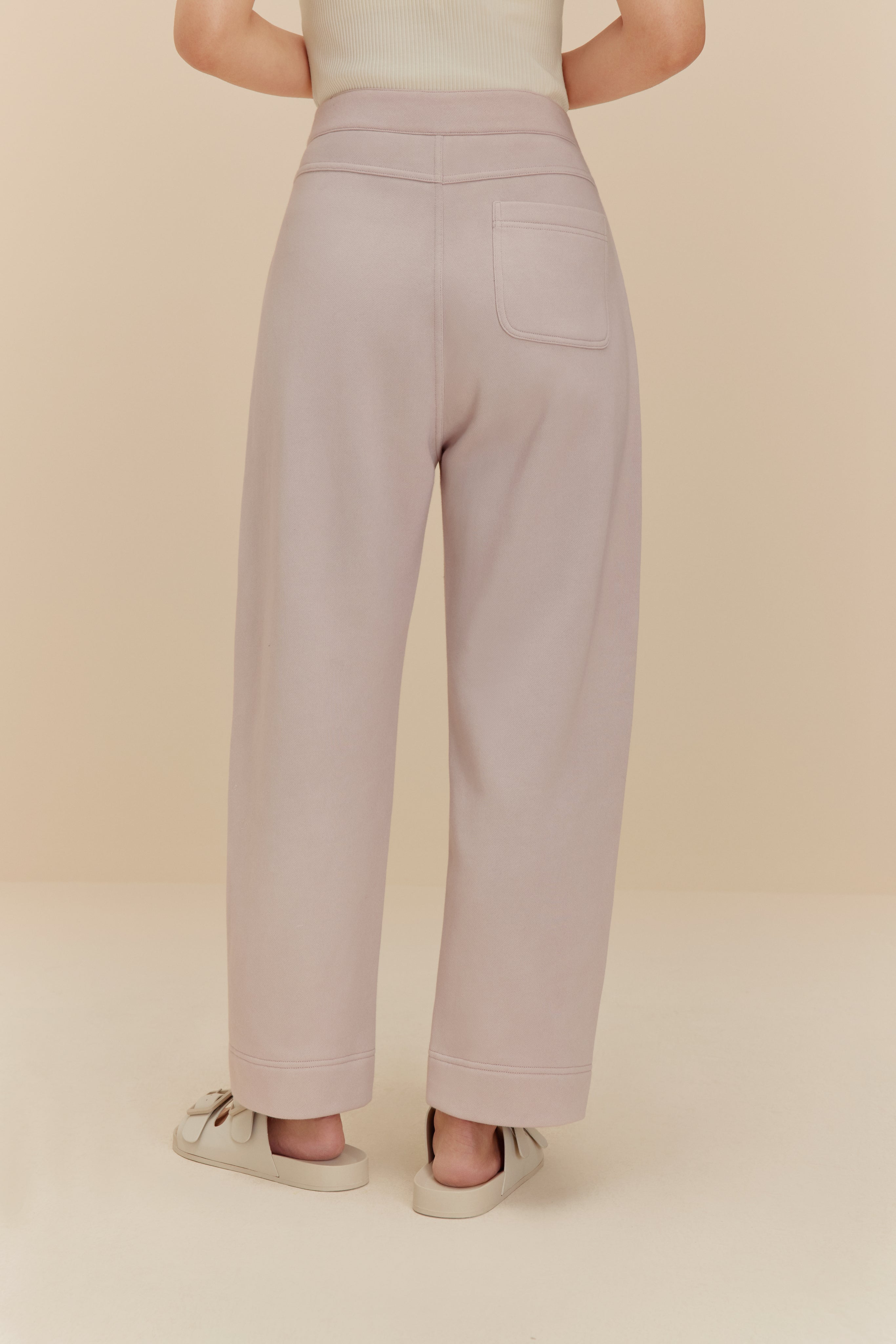 back of woman in light purple pants