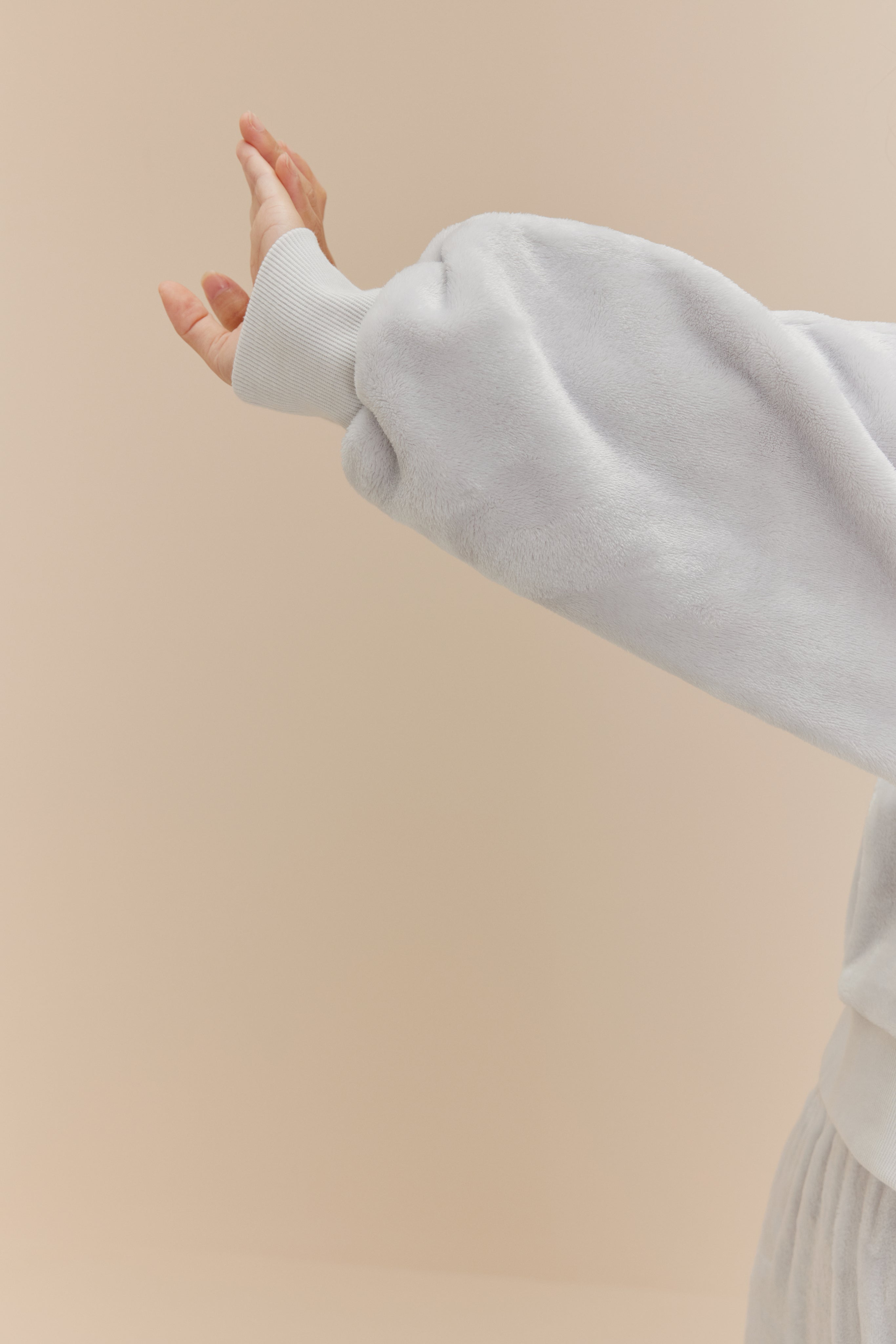 an extended arm in a fleece top