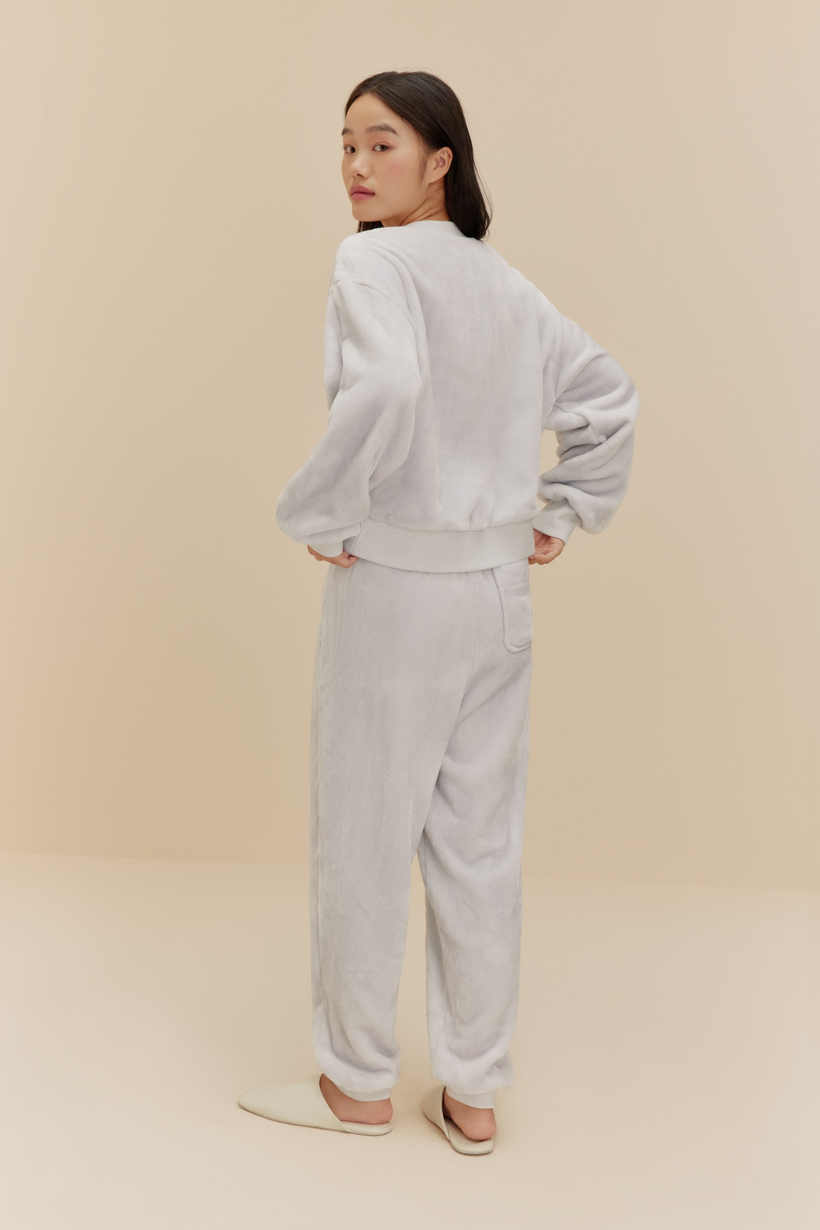 woman wearing light blue fleece set from back