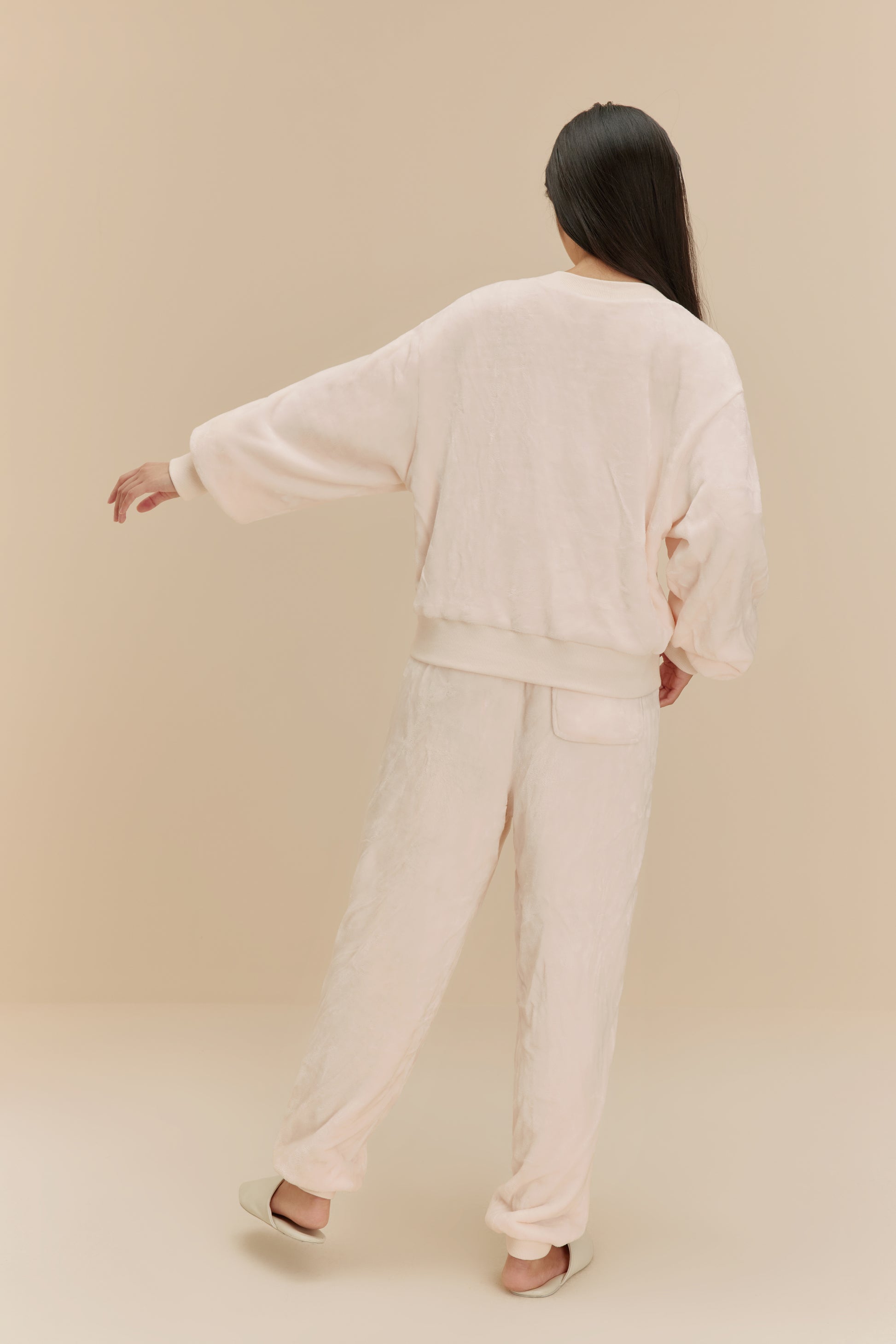 woman wearing white fleece pajama set from back