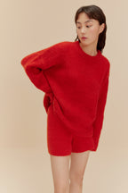 Woman in fuzzy red shorts and top