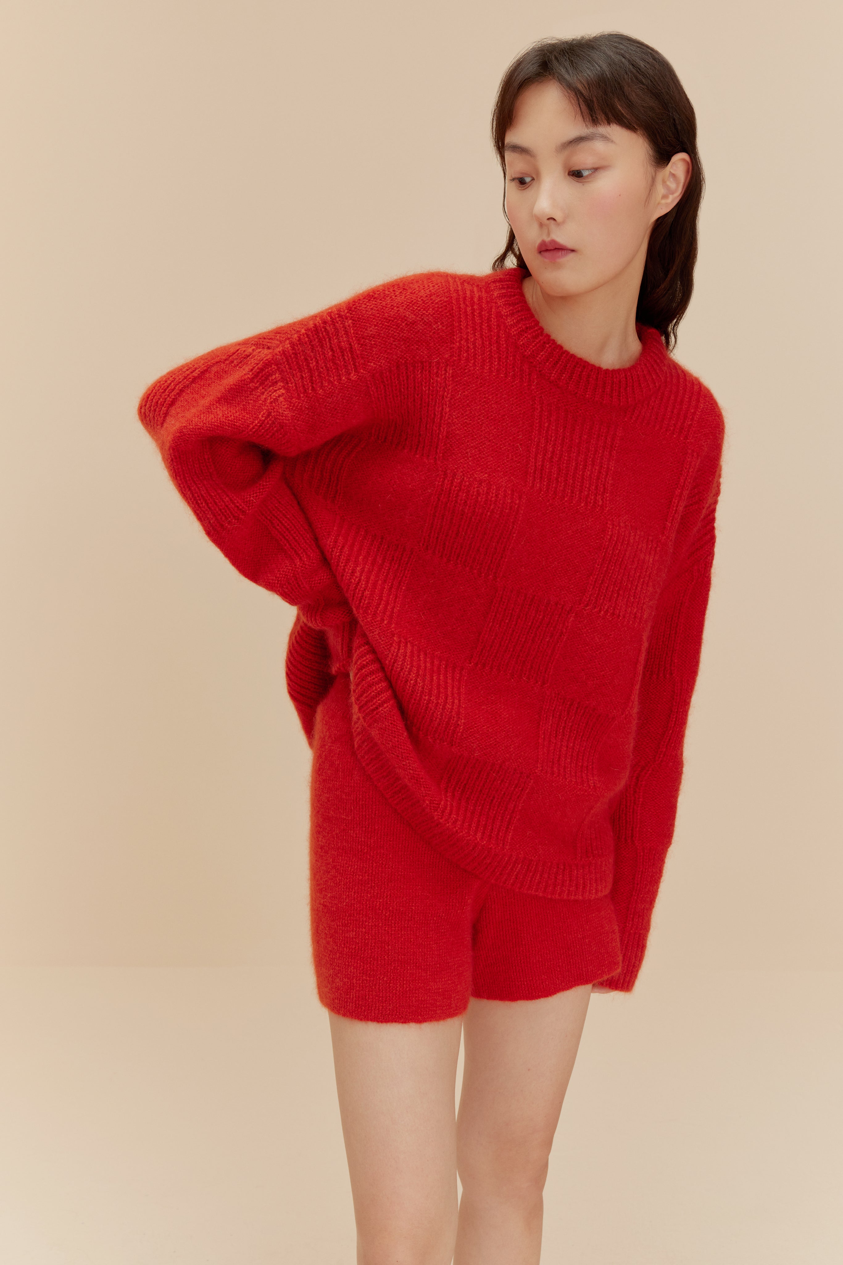Woman in fuzzy red shorts and top