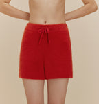 a woman wearing fuzzy red shorts