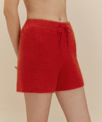 Woman in fuzzy red shorts