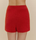 The back of a woman wearing fuzzy red shorts