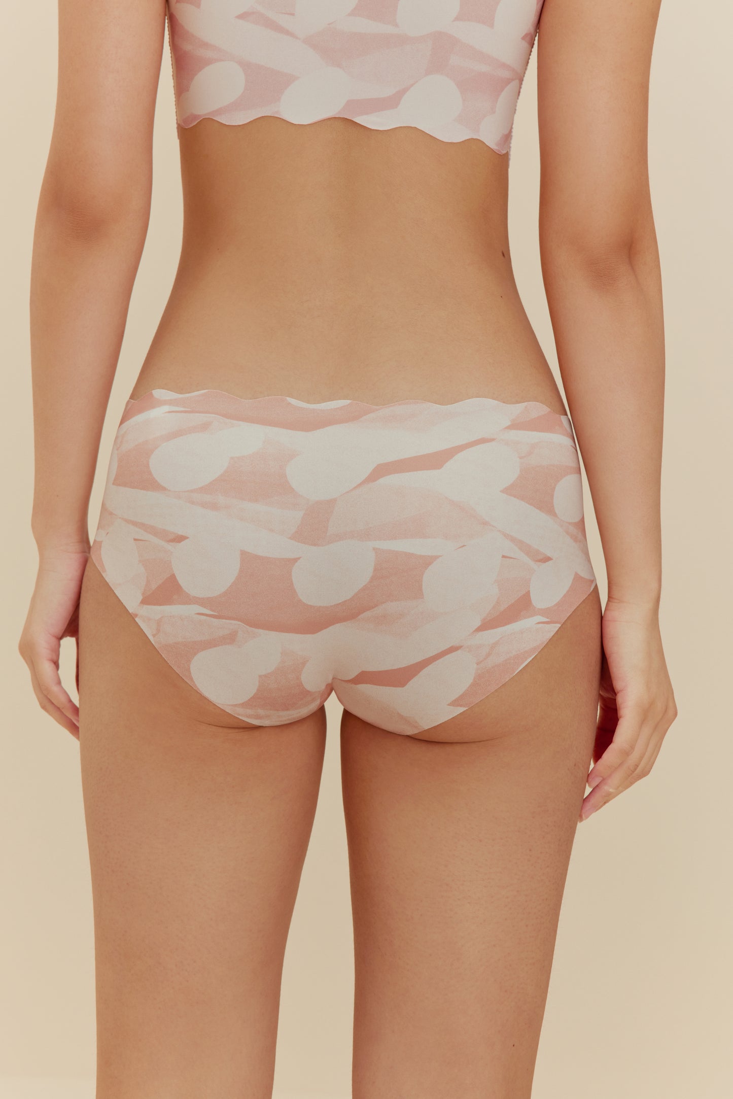back of woman in pink pattern brief