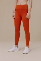 Woman wearing orange leggings