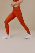 Woman wearing orange leggings