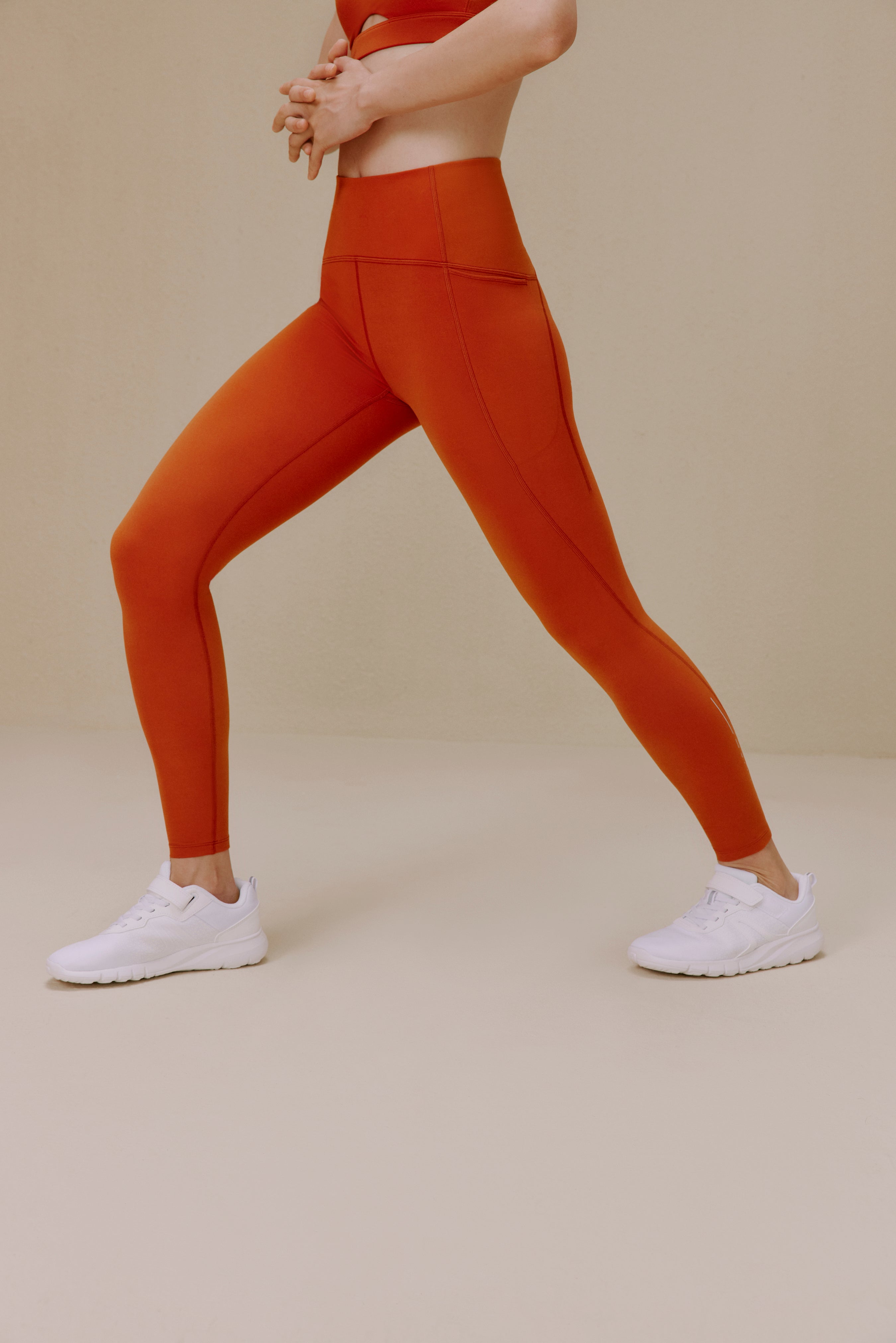 Woman wearing orange leggings
